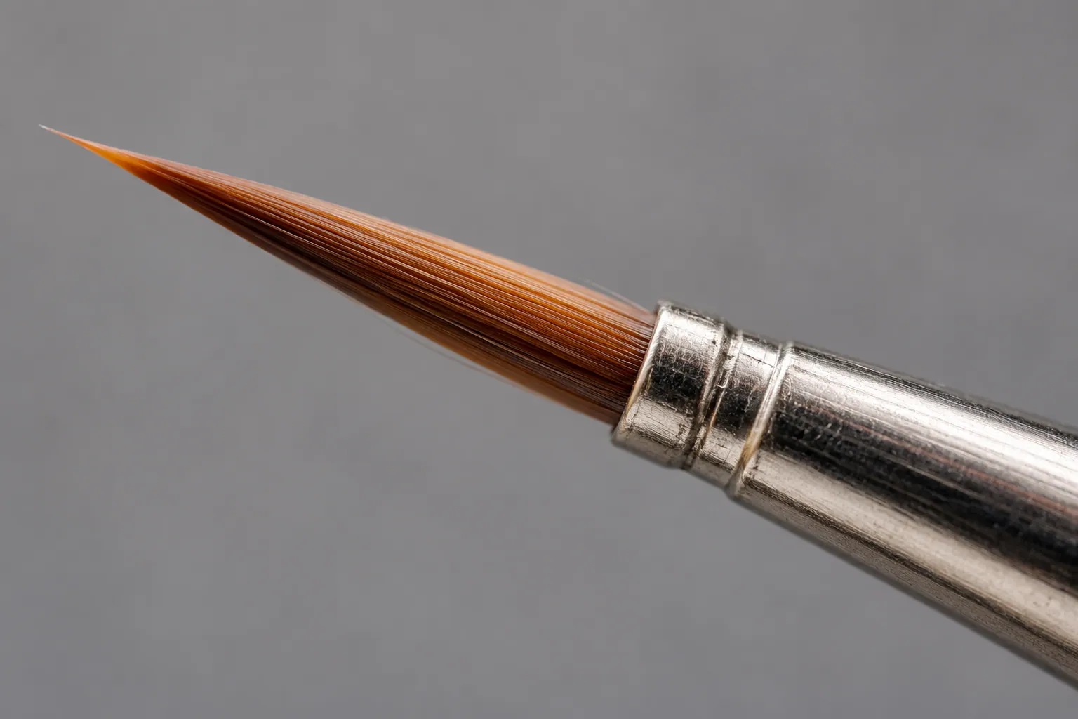 Extreme macro of 7 mm micro-liner nail art brush tip and nickel ferrule.